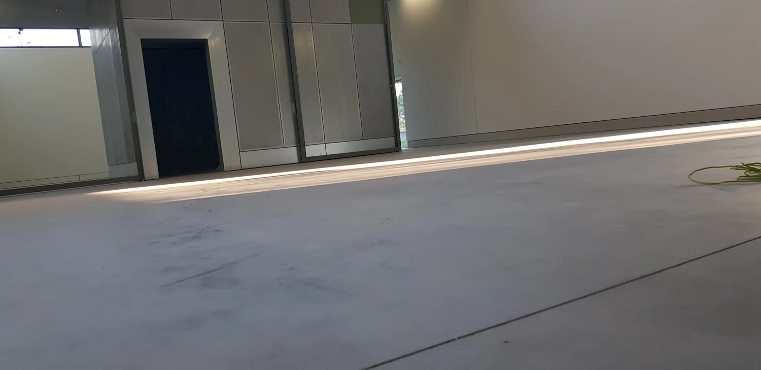 Gepolierde betonvloer bij de glasgevel van het Collectiepaviljoen Middelheim